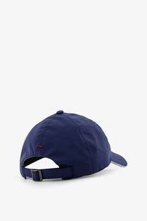 Back view of brunello cucinelli men’s navy blue baseball hat with subtle red logo and silver adjustable strap