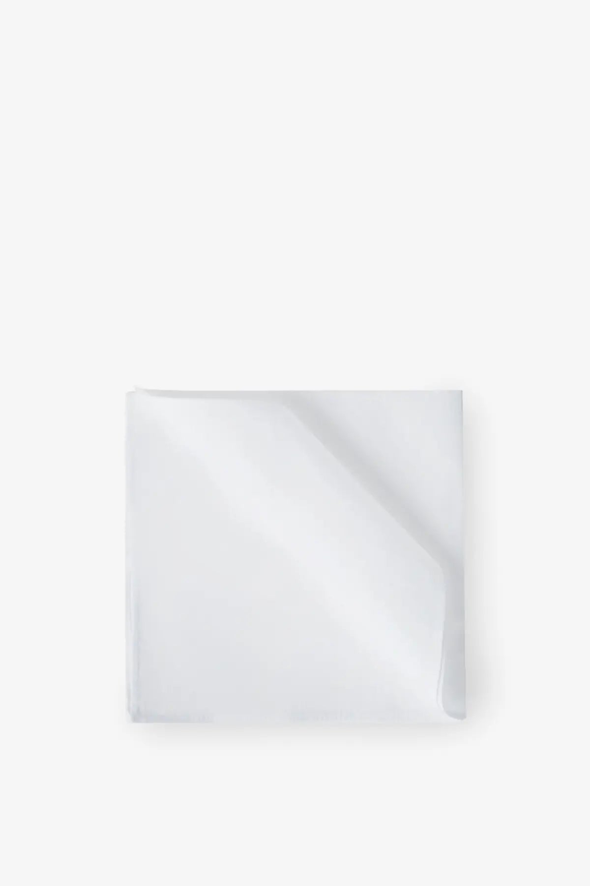 A crisp white silk pocket square by Brunello Cucinelli with subtle sheen and clean edges neatly folded