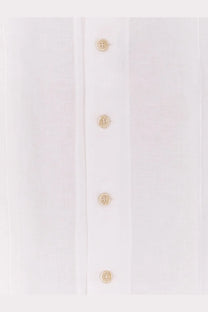 A row of four small beige buttons on the front placket of a brunello cucinelli men’s easy fit white linen shirt