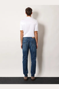 Brunello Cucinelli men’s leisure fit dark blue cotton denim jeans with classic fit and subtle thigh fading