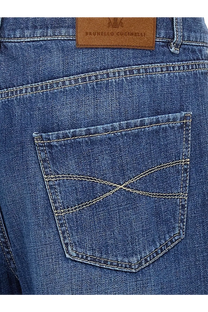 Blue denim brunello cucinelli men’s leisure fit cotton jeans back side with brown leather patch and white stitching on pocket