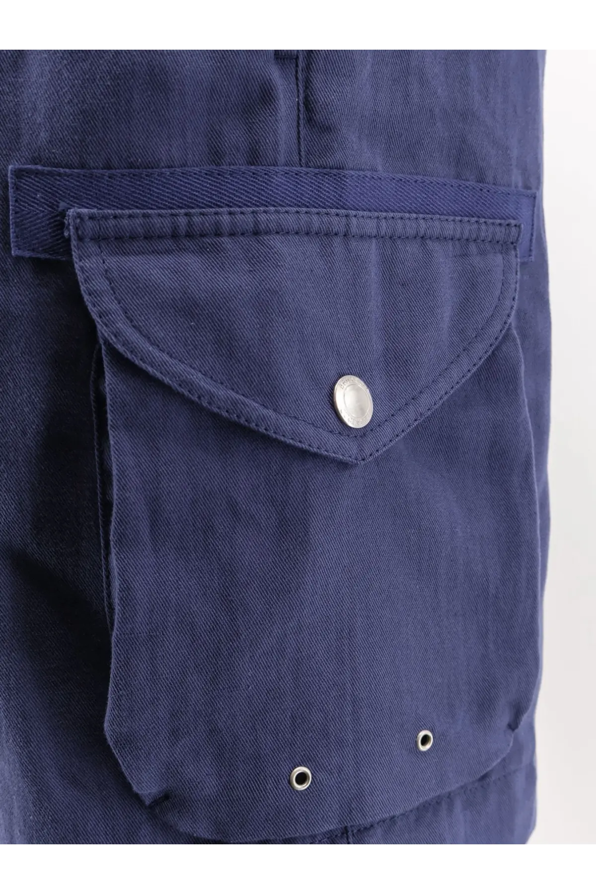 Deep navy blue cargo pocket with silver button and three metal grommets on brunello cucinelli men’s linen cotton shorts