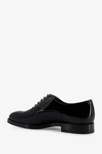 Brunello Cucinelli men’s black lace-up derby shoe in polished patent leather with classic design
