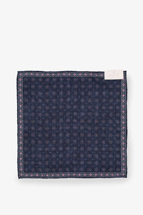 A brunello cucinelli men’s silk pocket square in navy blue with a pink and white geometric pattern and ornate border design