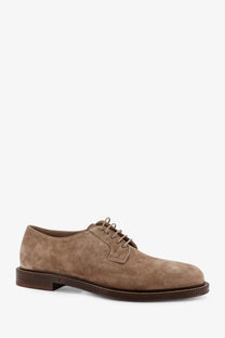 Brunello Cucinelli men’s grey suede derby shoe with tan suede upper, brown leather laces, and dark brown rubber sole