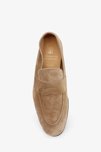 Tan suede Brunello Cucinelli men’s loafers with classic slip-on design and brand label visible inside