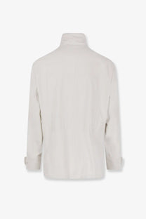 Brunello Cucinelli men’s waterproof sahariana white jacket with off-white turtleneck and structured seam detailing