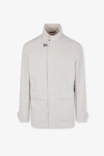 Brunello Cucinelli men’s waterproof sahariana white jacket with silver clasps, patch pockets, and rolled cuff sleeves