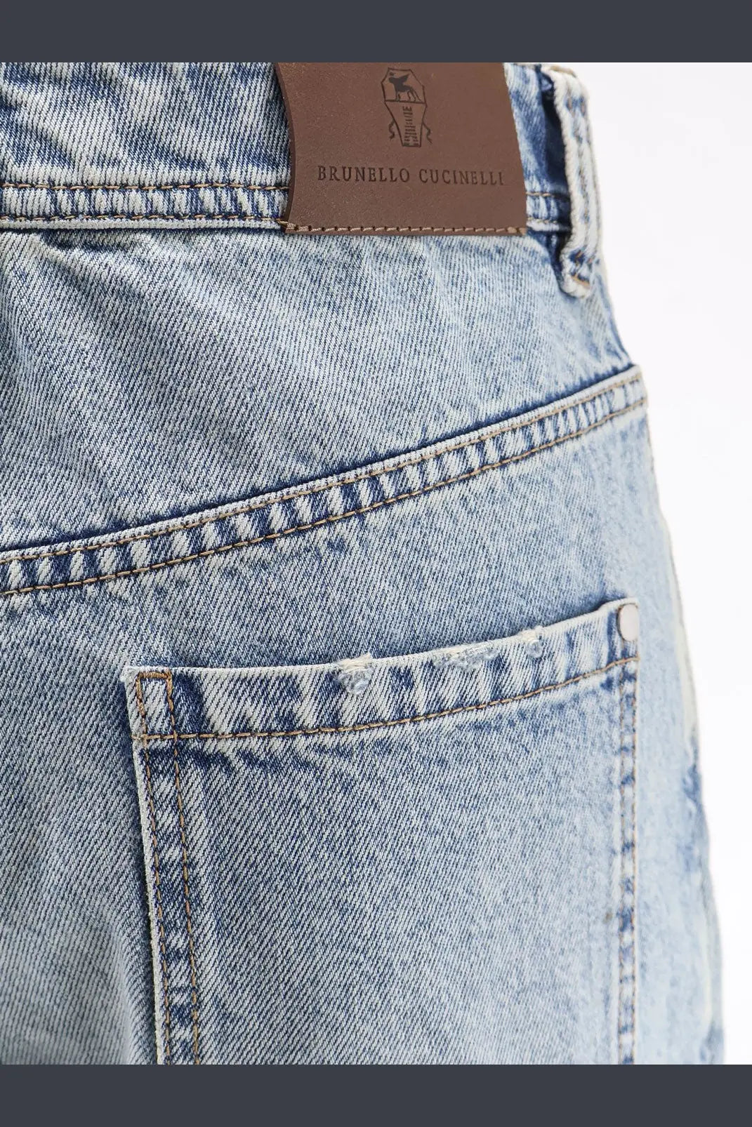 Light-wash denim brunello cucinelli women’s the baggy jean tapered leg with brown leather brand tag on the back