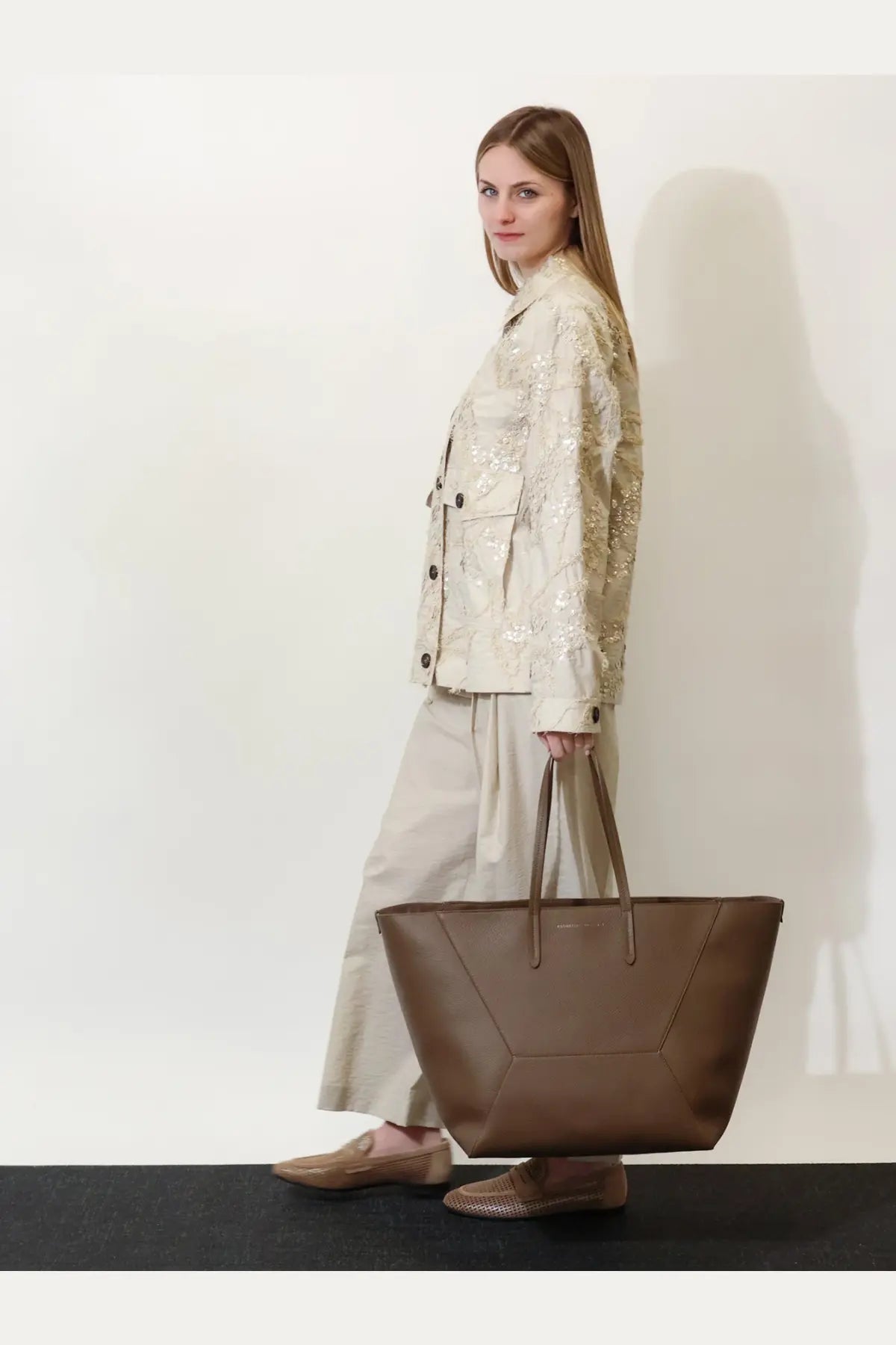 Brunello Cucinelli women’s brown leather tote bag with structured geometric design and top handles