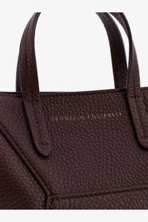 Brunello Cucinelli women’s red leather crossbody bag featuring a rich brown textured tote with embossed brand name