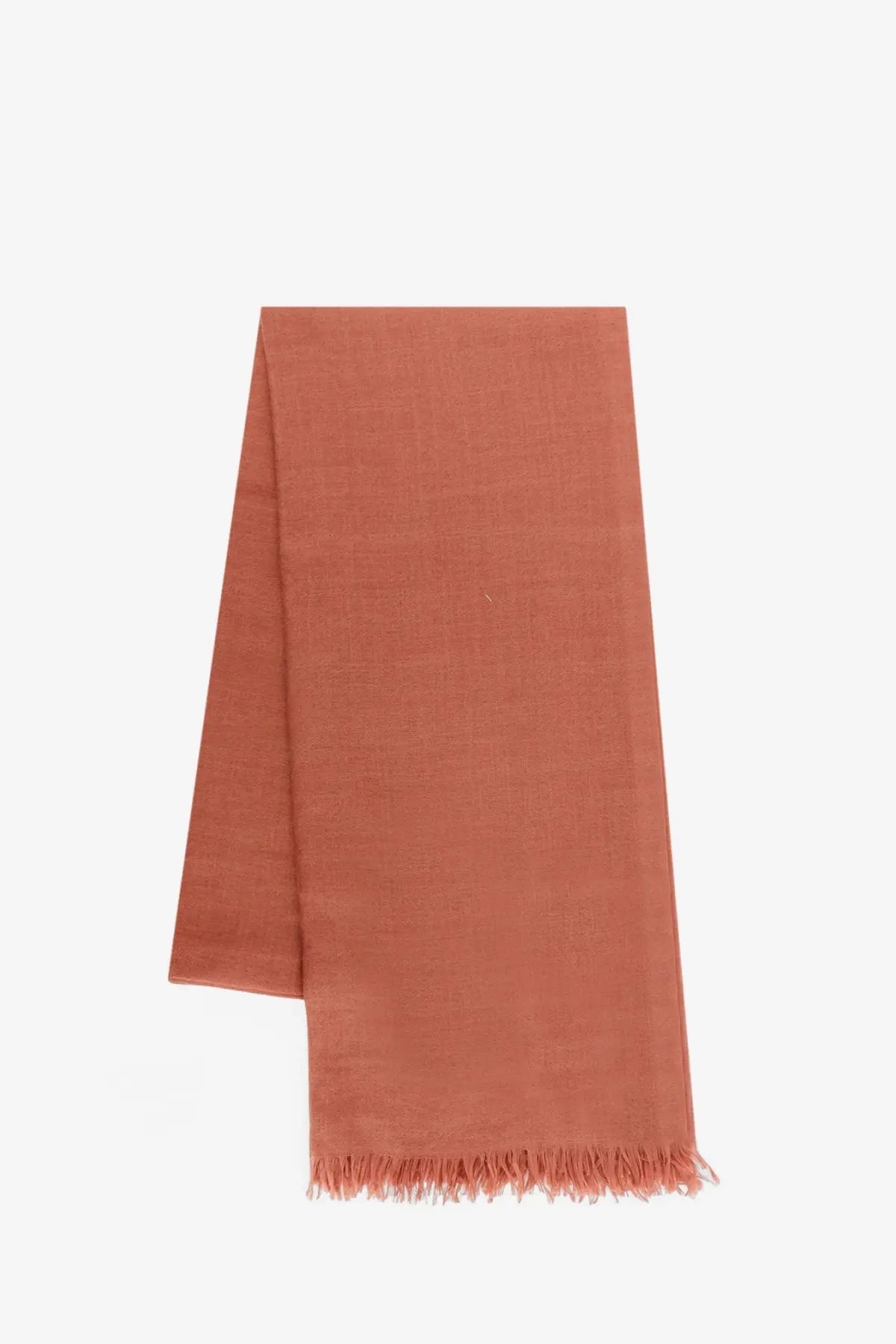 A soft terracotta-colored Brunello Cucinelli women’s cashmere and silk scarf with textured weave and fringed edges