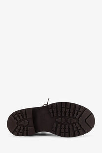 Dark brown rubber sole with rugged textured tread and visible stitching on brunello cucinelli women’s leather ankle boots gold