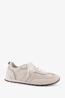 Brunello Cucinelli women’s cream leather sneaker with white laces and brown rubber sole for casual wear