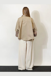 Brunello Cucinelli women’s beige oversized shirt made of linen and cotton blend with striped cuffs