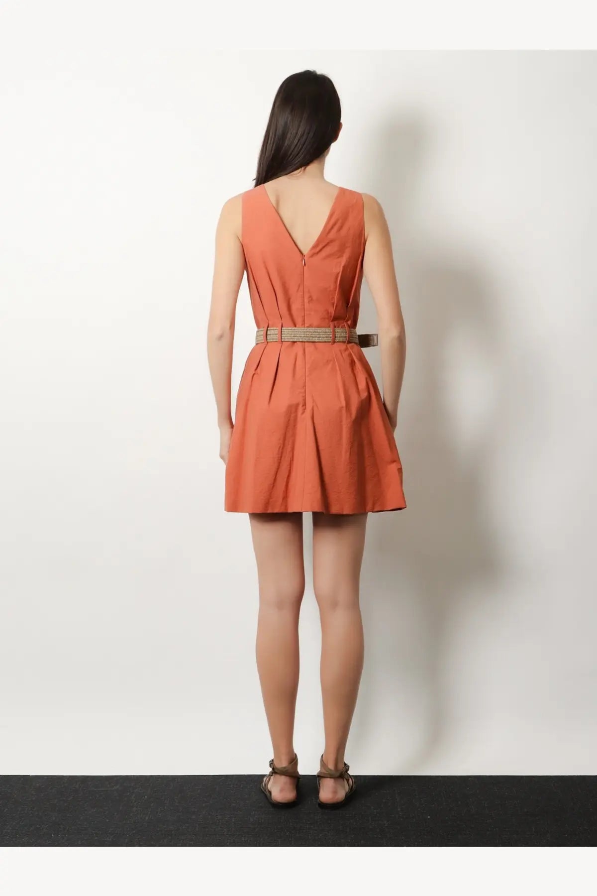 Brunello Cucinelli women’s coral sleeveless mini dress with v-back and pleated skirt back view