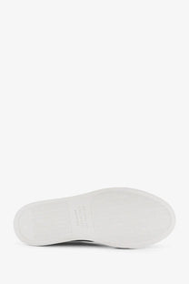 White rubber sole with textured grip and embossed logo on brunello cucinelli women’s beige suede sneakers