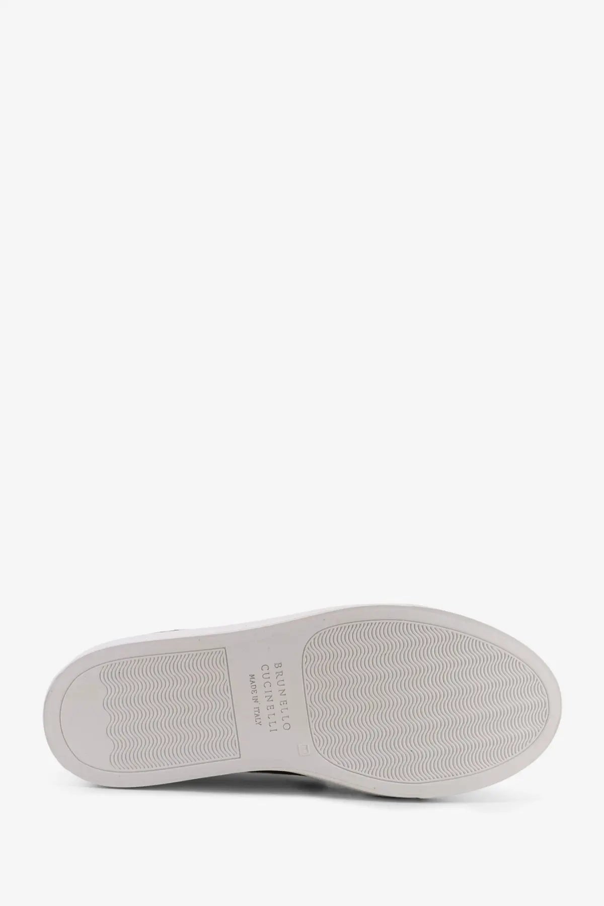 Back side of brunello cucinelli women’s green suede sneakers with white rubber sole and wavy tread pattern