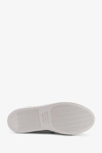 Back side of brunello cucinelli women’s green suede sneakers with white rubber sole and wavy tread pattern