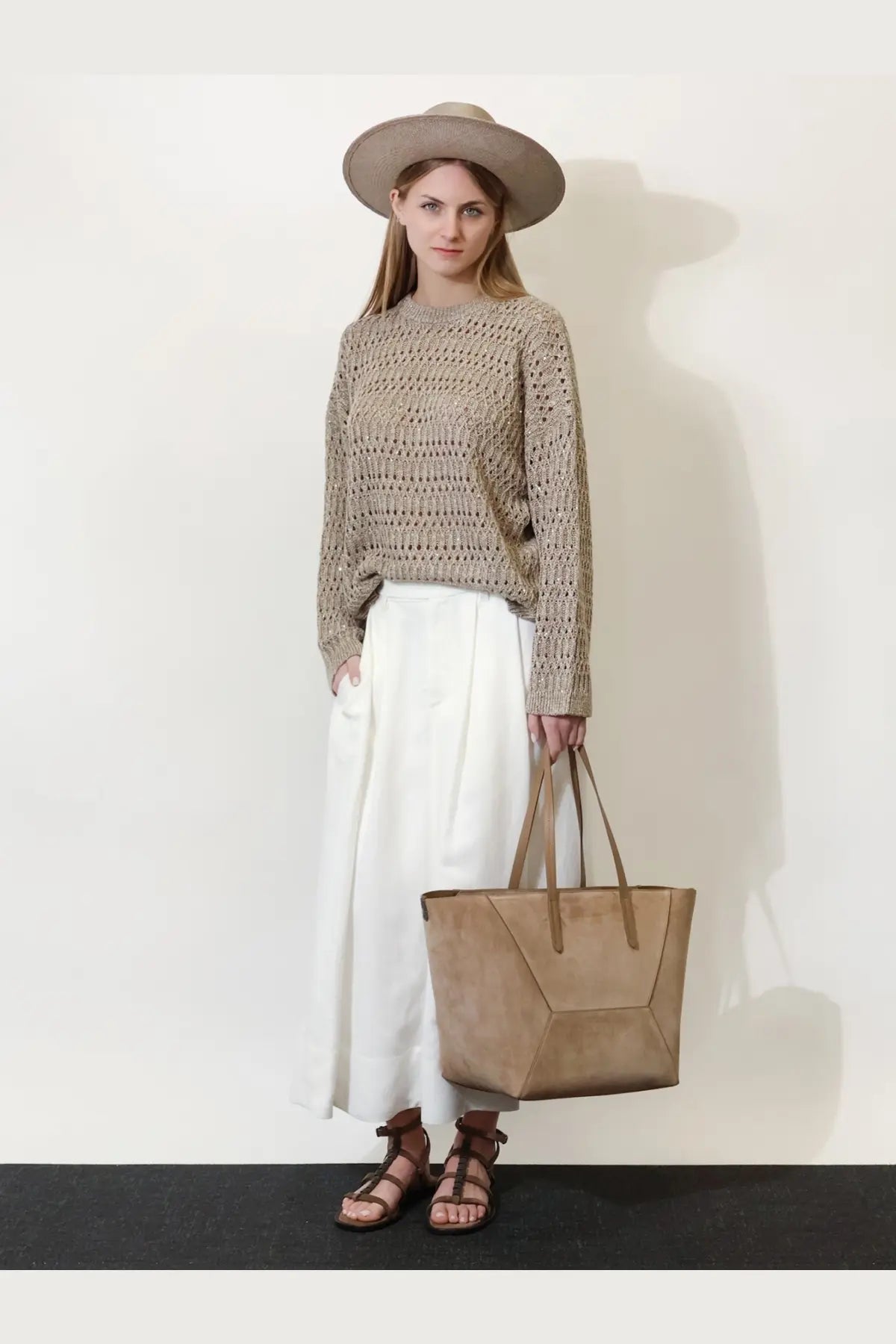 Beige suede tote bag with geometric angular design and matching handles paired with brunello cucinelli white viscose and linen skirt