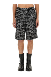 Burberry men’s black Bermuda shorts with repeating white chain-link pattern and lightweight fabric for casual wear