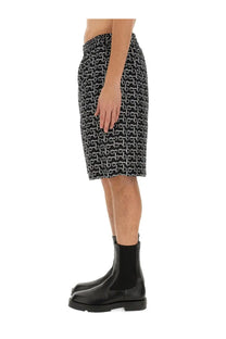 Burberry men’s black knee-length Bermuda shorts with white horsebit logo pattern all over print design