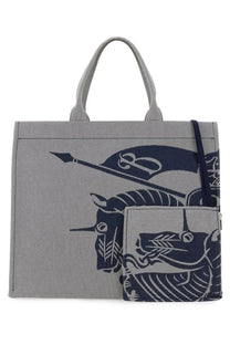 Burberry men’s grey canvas tote bag with bold navy blue graphic of stylized mythical creatures and flags