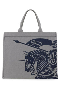 Burberry men’s grey canvas tote bag with bold navy blue knight on horseback graphic on the front