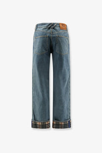 Burberry men’s Dexter blue denim jeans with plaid cuff and brown leather brand patch at the waistband