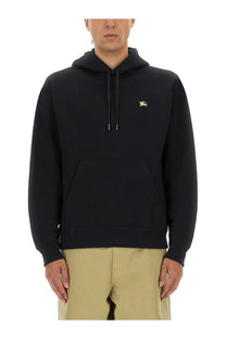 Burberry men’s black hoodie with gold embroidered logo on chest and matching drawstrings in cotton material