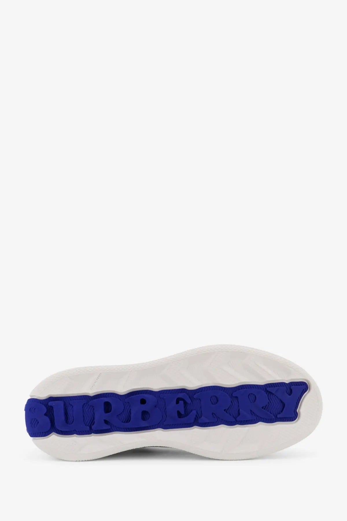 White rubber sole with bold blue embossed burberry logo on burberry men’s low top white leather sneakers