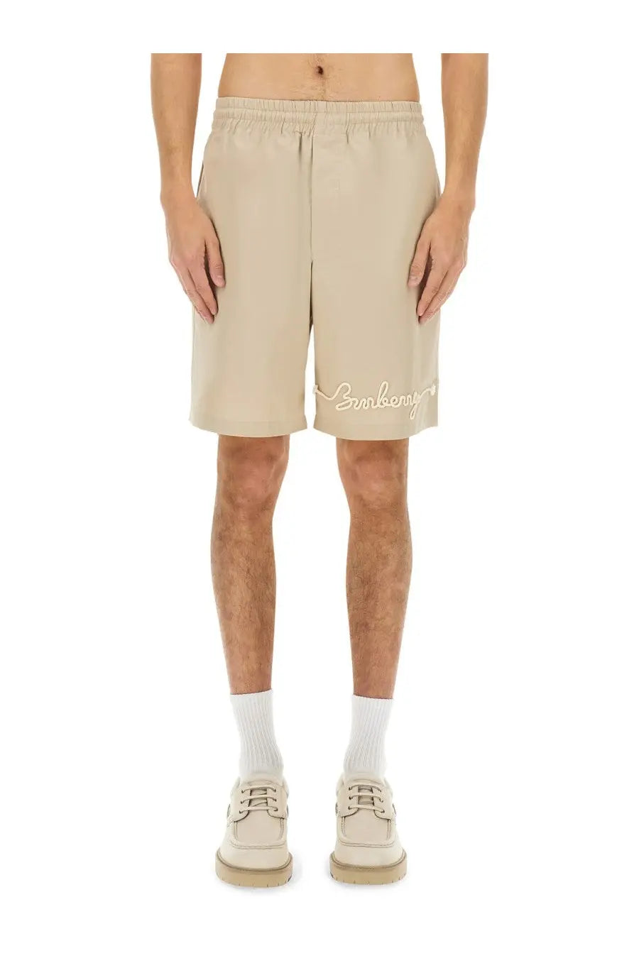 Beige linen burberry men’s nautical style shorts with subtle embroidered logo on the lower right leg