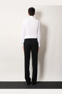 A man wearing a Burberry men’s Sam organic cotton shirt white paired with black tailored trousers