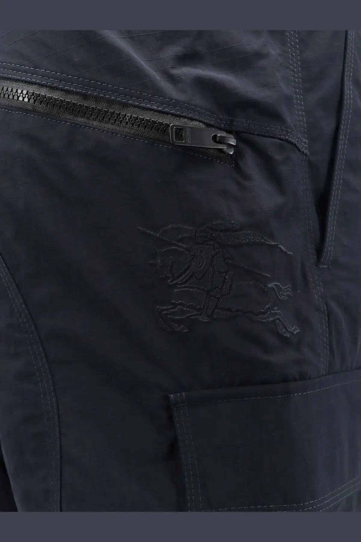 Black arcteryx nylon pants with a subtle embroidered logo on the thigh in a burberry mens sidcot nylon trousers blue product