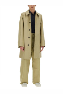 Beige trench coat with dark brown buttons and classic collar paired with burberry men’s straight leg pants beige