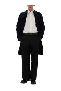 Black trench coat with structured collar and epaulets paired with burberry men’s tailored black pants
