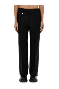 Burberry men’s tailored black trousers with a sleek straight-leg cut and subtle silver circular button waistband