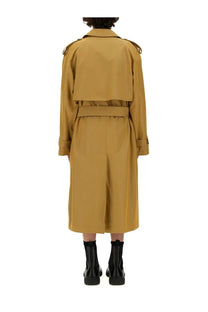 Burberry men’s trench coat in beige featuring structured mustard yellow fabric with a belted waist and epaulets