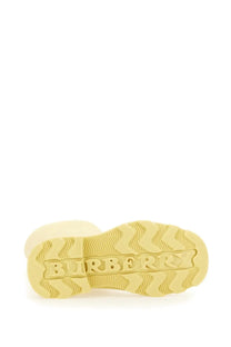 Cream-colored rubber sole with embossed Burberry logo and wavy tread on Burberry women’s Marsh yellow boot