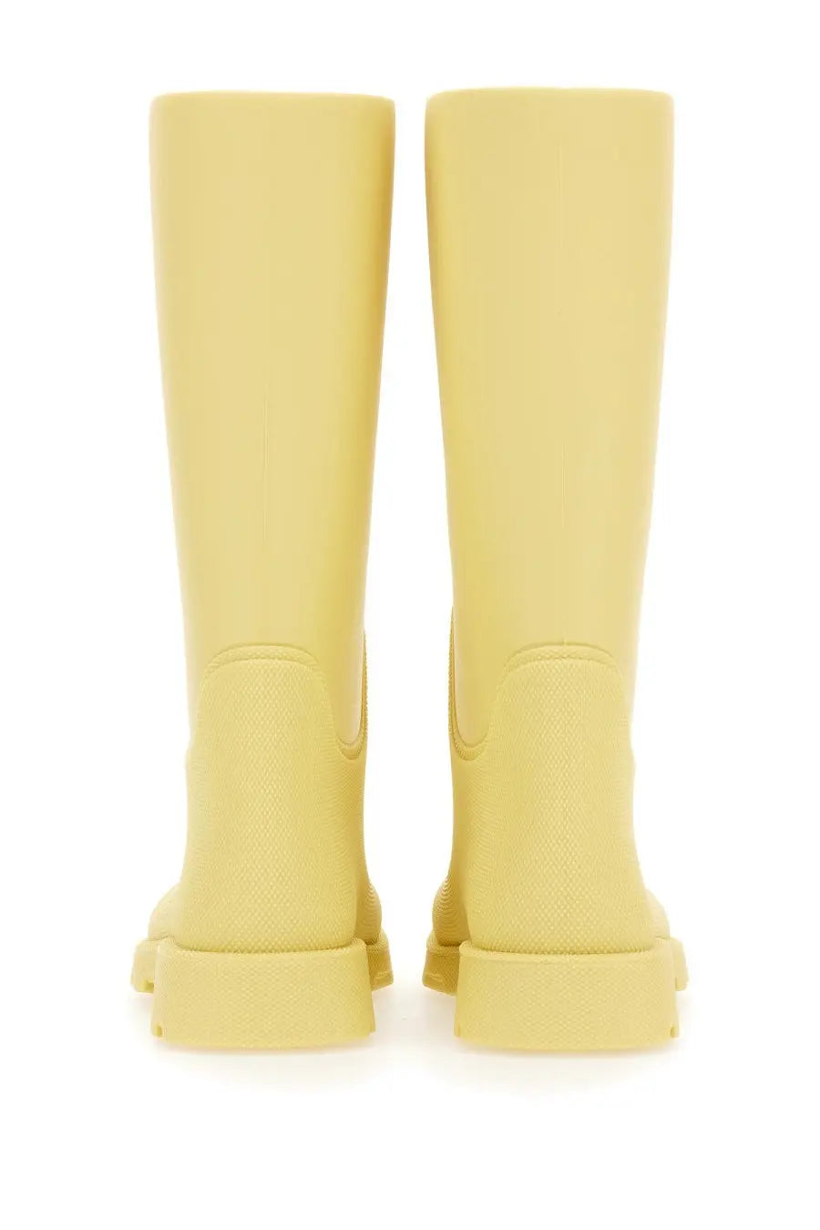 Pair of burberry women’s pale yellow rubber boots with textured matte finish and chunky soles