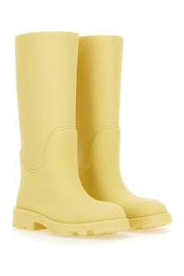 Pair of Burberry women’s marsh yellow rubber boots with textured surface and chunky sole for outdoor wear
