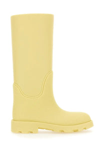 Burberry women’s pale yellow rubber boot with textured upper and chunky treaded sole in marsh yellow color