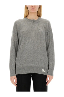 Burberry women’s grey cashmere sweater with silver toggle closure and embroidered logo on lower left hem