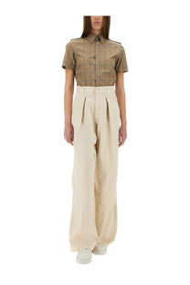Beige high-waisted pleated wide-leg trousers paired with brown Burberry women’s cotton check shirt front view
