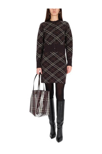 Brown and white plaid Burberry tote bag with black handles alongside women’s Ginny skirt brown