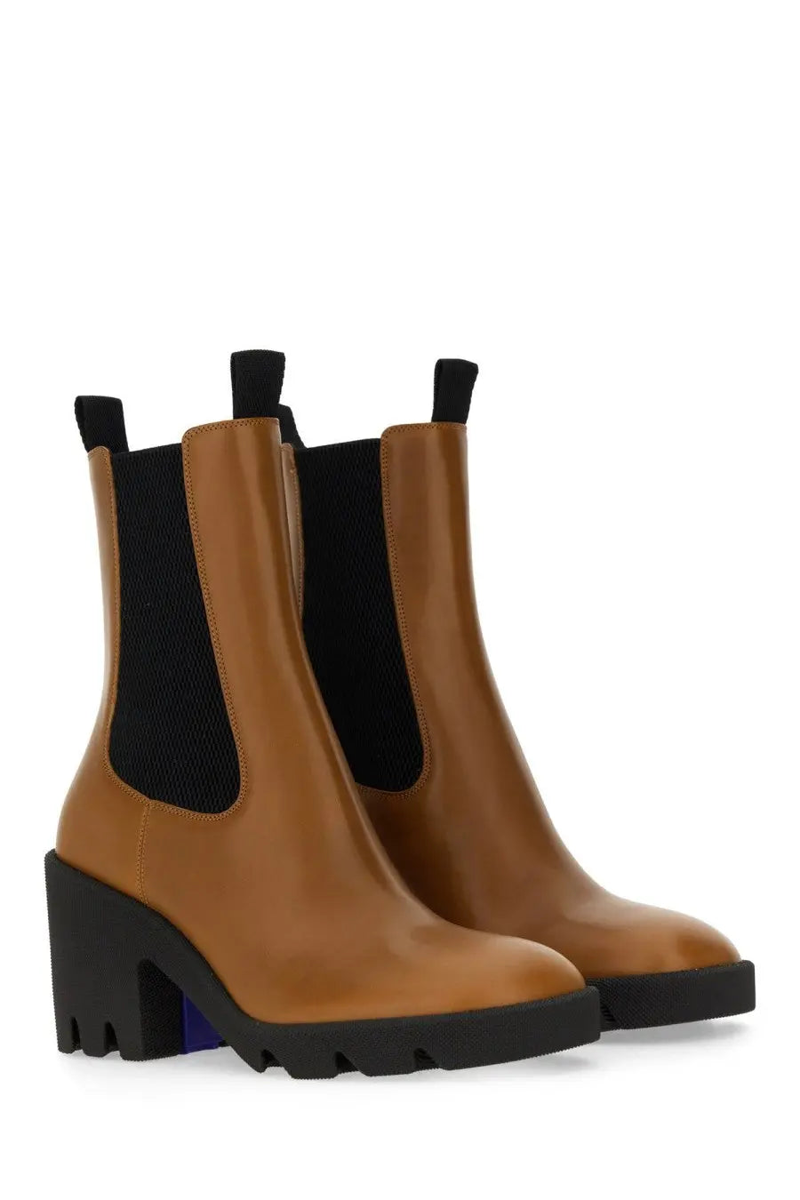 Burberry women’s beige leather chelsea boots with tan leather, black elastic panels, and chunky black heel