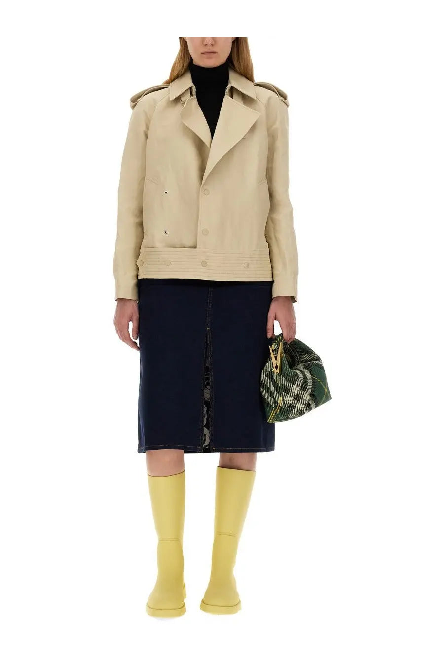 Beige trench coat with shoulder pads and button closures paired with burberry women’s mini peg bag green