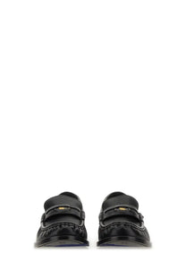 Burberry women’s black leather moccasin cadet loafers with glossy finish and gold tone logo strap detail