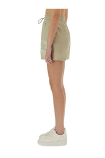 Beige Burberry women’s nylon athletic shorts with a drawstring waistband and subtle logo patch on the side