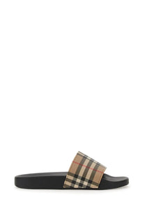 Burberry women’s slide sandal with black rubber sole and beige black red checkered fabric strap featuring Burberry pattern